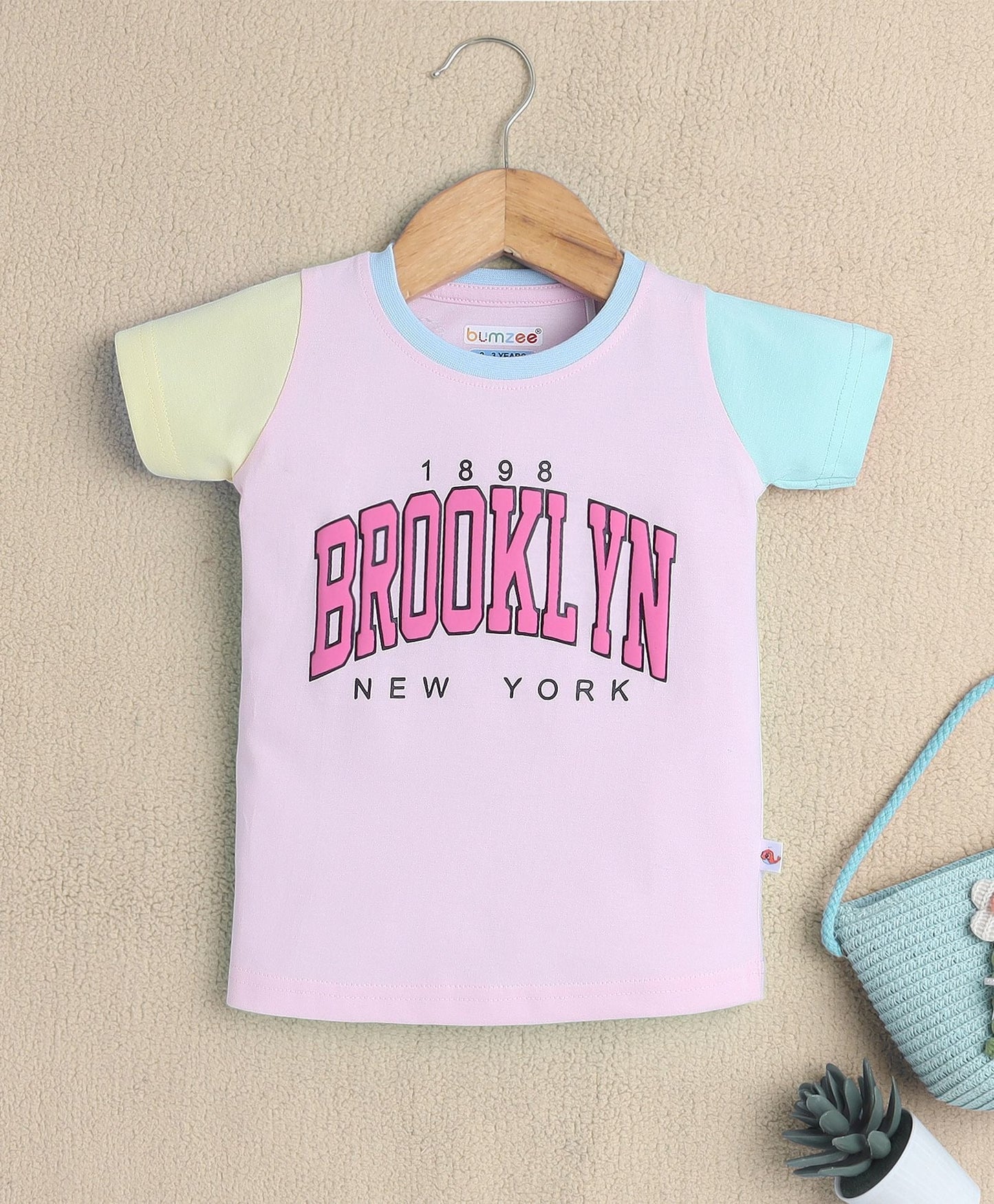 Stay warm and trendy in Bumzee’s cotton T-shirt—classic print and comfy slip-on style!
